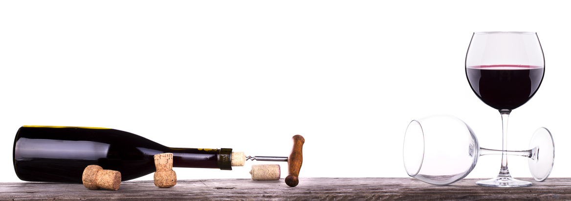 red wine and a bottle on a vintage wooden table isolated over white background