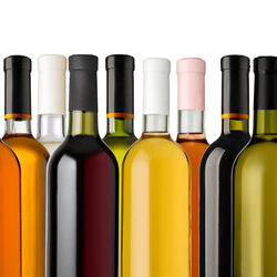 Some wine bottles in front of white background
