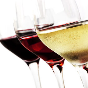 Three wine glasses over white background.  White wine, rose, and red.